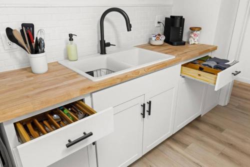 a kitchen with a sink and a wooden counter top at Halcyon Haven - A Heavenly Homestead for 4 in Morton