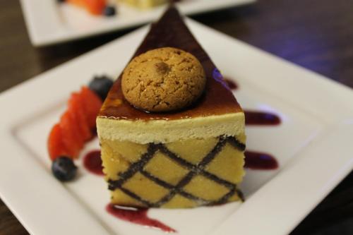 a piece of cake with a cookie on top on a plate at The Swan Motel, Gillingham in Beccles