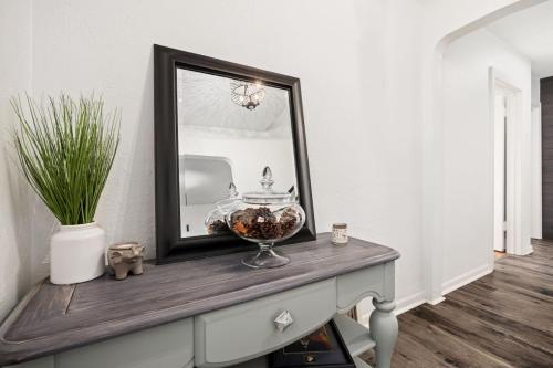 a mirror on a dresser with a bowl on it at Suburban Sanctuary 3BD Perfect for Long Stays in Pekin