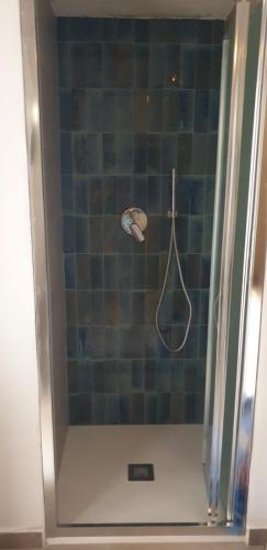 a bathroom with a shower with a tennis racket at Casa Nonna Rosa in Santa Marina Salina
