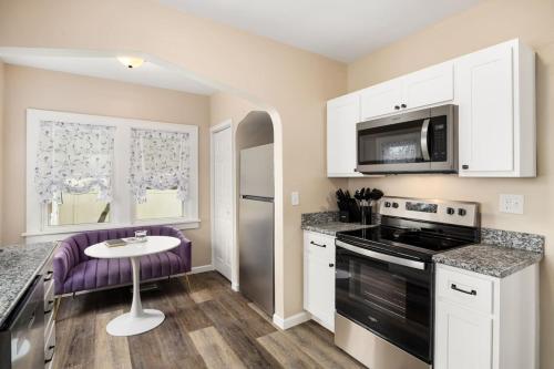a kitchen with white cabinets and a purple counter top at Tranquil 3 Bed Retreat Sleeps 7 in Peoria