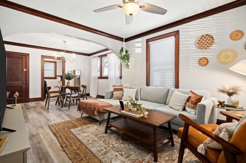 a living room with a couch and a table at Mid-Century Bohemian Escape in Peoria Heights