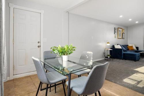 a dining room with a glass table and chairs at The Modern Elm Escape a cozy 2bd in the Heights in Peoria Heights