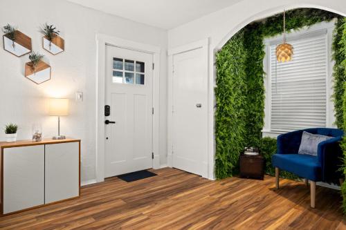 a living room with a blue chair and a green wall at The Heights Hideaway 2BR Gem in Peoria
