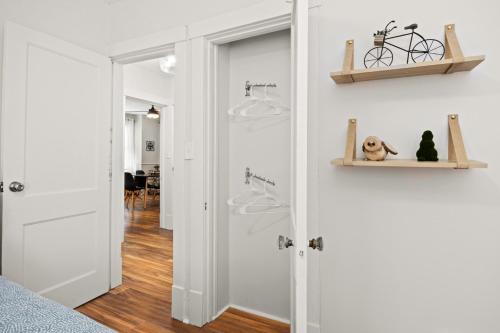 a bedroom with white walls and a door with a dog on it at The Heights Hideaway 2BR Gem in Peoria
