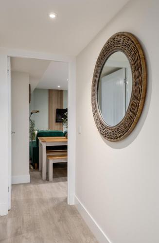 a mirror on a wall in a living room at Central Stirling City Escape in Stirling