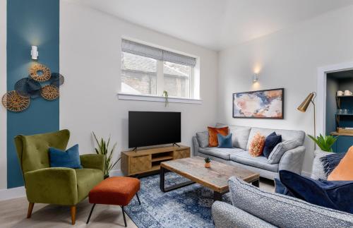 a living room with a couch and a tv at City Centre Haven Apartment in Stirling
