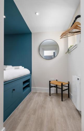 a bathroom with a blue sink and a mirror at City Centre Haven Apartment in Stirling