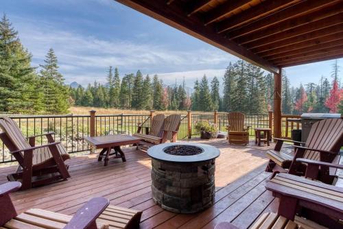 a patio with chairs and a fire pit on a deck at Montana Mountain Getaway in Creston
