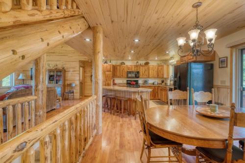 a dining room and kitchen with a large wooden table at Montana Mountain Getaway in Creston