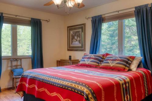 a bedroom with a large bed with blue curtains at Montana Mountain Getaway in Creston
