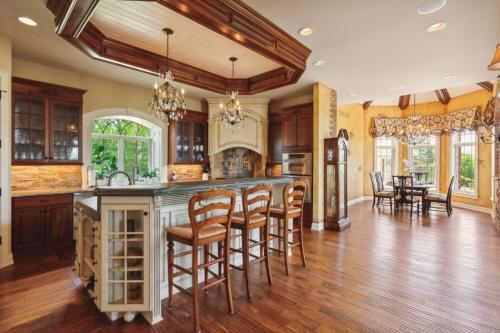 a kitchen with a island with bar stools at Grand Estate at the Preserve in Youngsdale