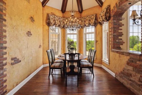a dining room with a table and chairs at Grand Estate at the Preserve in Youngsdale