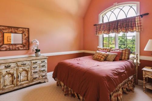 a bedroom with a bed and a window at Grand Estate at the Preserve in Youngsdale