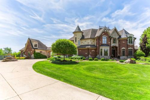 a large house with a green lawn at Grand Estate at the Preserve in Youngsdale