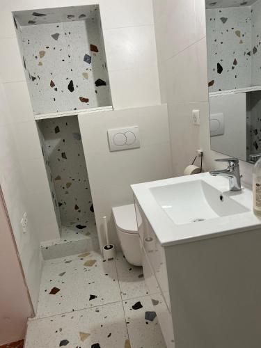 a bathroom with a sink and a rock wall at Au cœur de Seillans, charmant logement, grande terrasse et panorama in Seillans