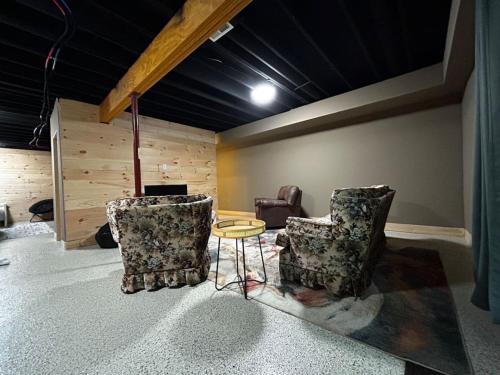 a living room with two chairs and a table at Wintervue-beautiful home at Alpine Lake in Terra Alta