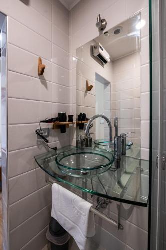 a bathroom with a glass sink and a shower at 4 TeTE in Vrhpolje