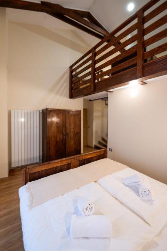 a bedroom with a bed with two towels on it at 4 TeTE in Vrhpolje