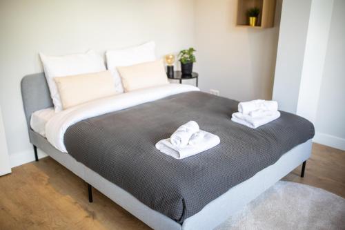 a bedroom with a bed with two towels on it at Villapark in Rotterdam