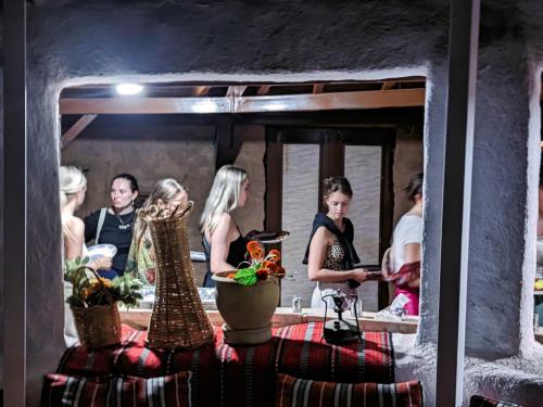 a group of people standing in front of a mirror at Wadi Rum Majestic Camp in Wadi Rum