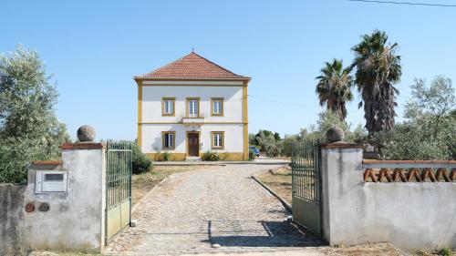 a house with a gate in front of it at Casa da Papoila in Abrantes