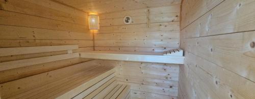 a wooden sauna with a light on the wall at 4seasons Apartments in Fonyód