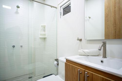 a bathroom with a glass shower and a sink at 201 Norte cali - The View in Cali