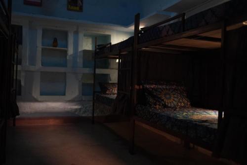 a room with two bunk beds in a dark room at BlaBla Hostel in Jodhpur