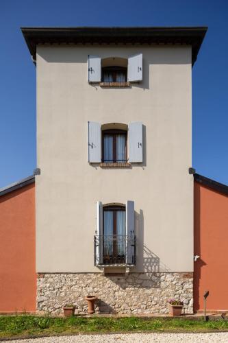 a white building with two windows and two balconies at Locanda Ca'Vejo srl in Megliadino San Vitale