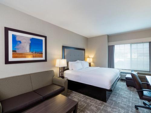 a hotel room with a bed and a couch at Holiday Inn West Yellowstone by IHG in West Yellowstone