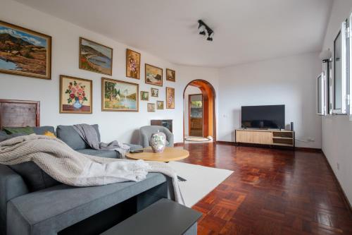 a living room with a couch and a table at Casa da Silva home in Funchal in Funchal