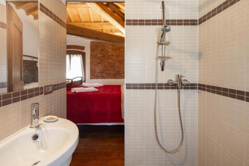 a bathroom with a shower and a sink and a room at Locanda Ca'Vejo srl in Megliadino San Vitale