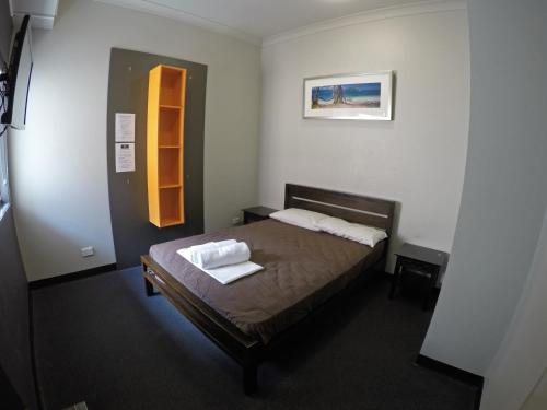 a bedroom with a bed and a desk at Global Backpackers Port Douglas in Port Douglas