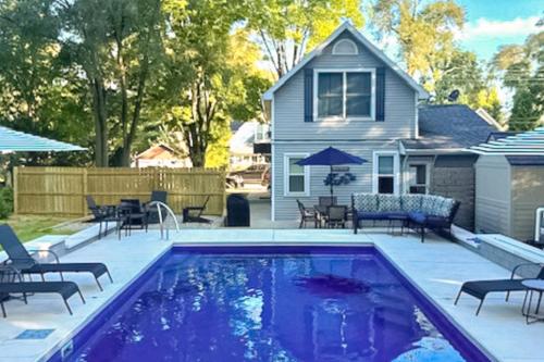 a swimming pool in front of a house at Merchant Street Retreat in New Buffalo