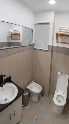 a bathroom with a sink and a toilet and a sink at Kawsay Apart in La Paz