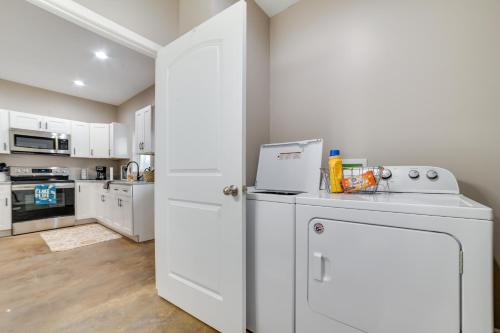 a kitchen with white cabinets and a white refrigerator at Pet-Friendly Murray Vacation Rental with Grill! in Murray