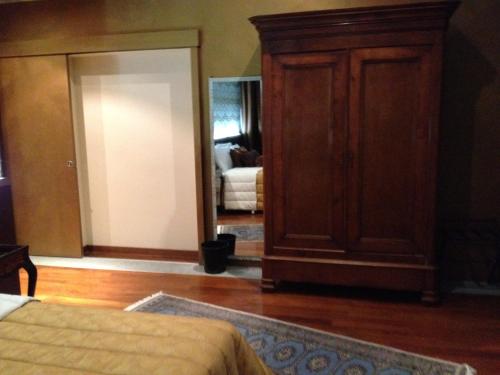 a bedroom with a wooden cabinet and a bed at Hotel Dei Pittori in Turin