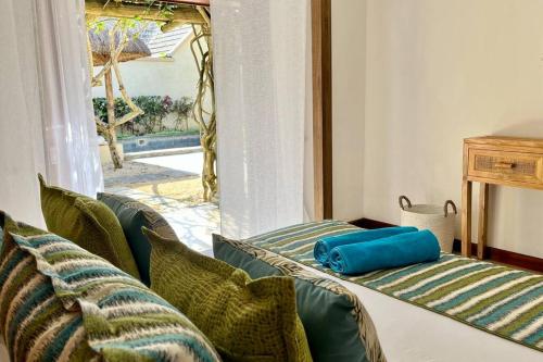 a living room with two beds and a window at Searenity Villa in Grand Baie