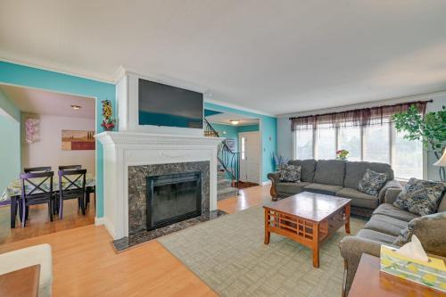 a living room with a fireplace with a tv above it at Pinebrook - Three Bedroom House in Lake George