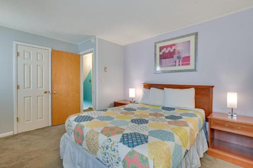 a bedroom with a bed with a colorful quilt at Pinebrook - Three Bedroom House in Lake George