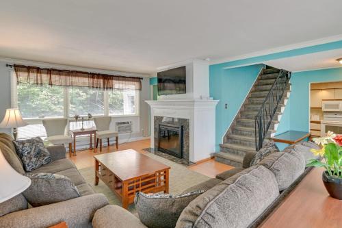 a living room with a couch and a fireplace at Pinebrook - Three Bedroom House in Lake George