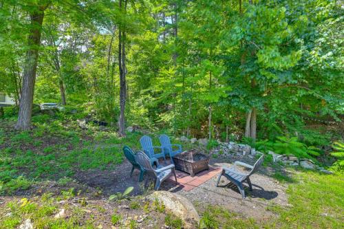 a group of blue chairs sitting around a fire pit at Pinebrook - Three Bedroom House in Lake George