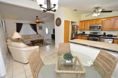 a kitchen and living room with a table and chairs at Cayman Cottage in Summerland Key