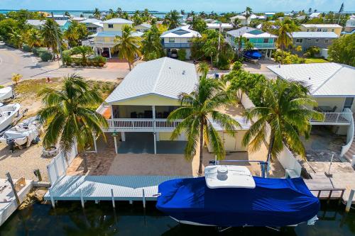 an aerial view of a resort with a boat in the water at Cayman Cottage in Summerland Key