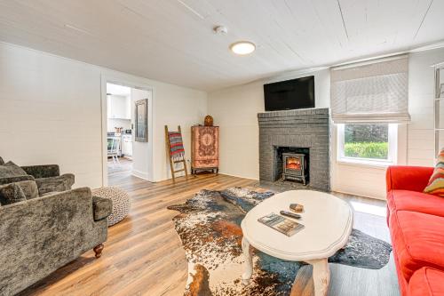 a living room with a couch and a fireplace at Cabin with Fire Pit - 7 Mi to Downtown Carrollton! in Carrollton
