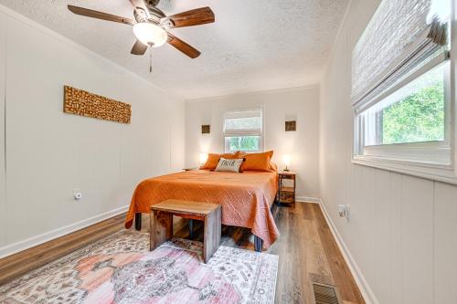 a bedroom with a bed and a ceiling fan at Cabin with Fire Pit - 7 Mi to Downtown Carrollton! in Carrollton