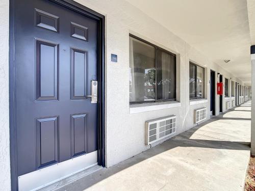a blue door on the side of a building at Stayable Kissimmee West in Kissimmee
