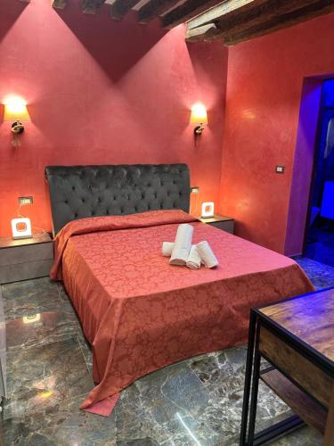 a red bedroom with a bed with red walls at Venice Rainbow Apartments BIENNALE in Venice