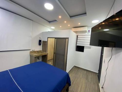 a bedroom with a blue bed in a room at Hotel deluxe oasis de la colina boutique in Girardot